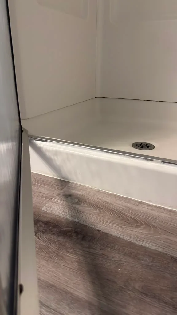 The same shower door track clean after cleaning by Dolane Cleaning Services