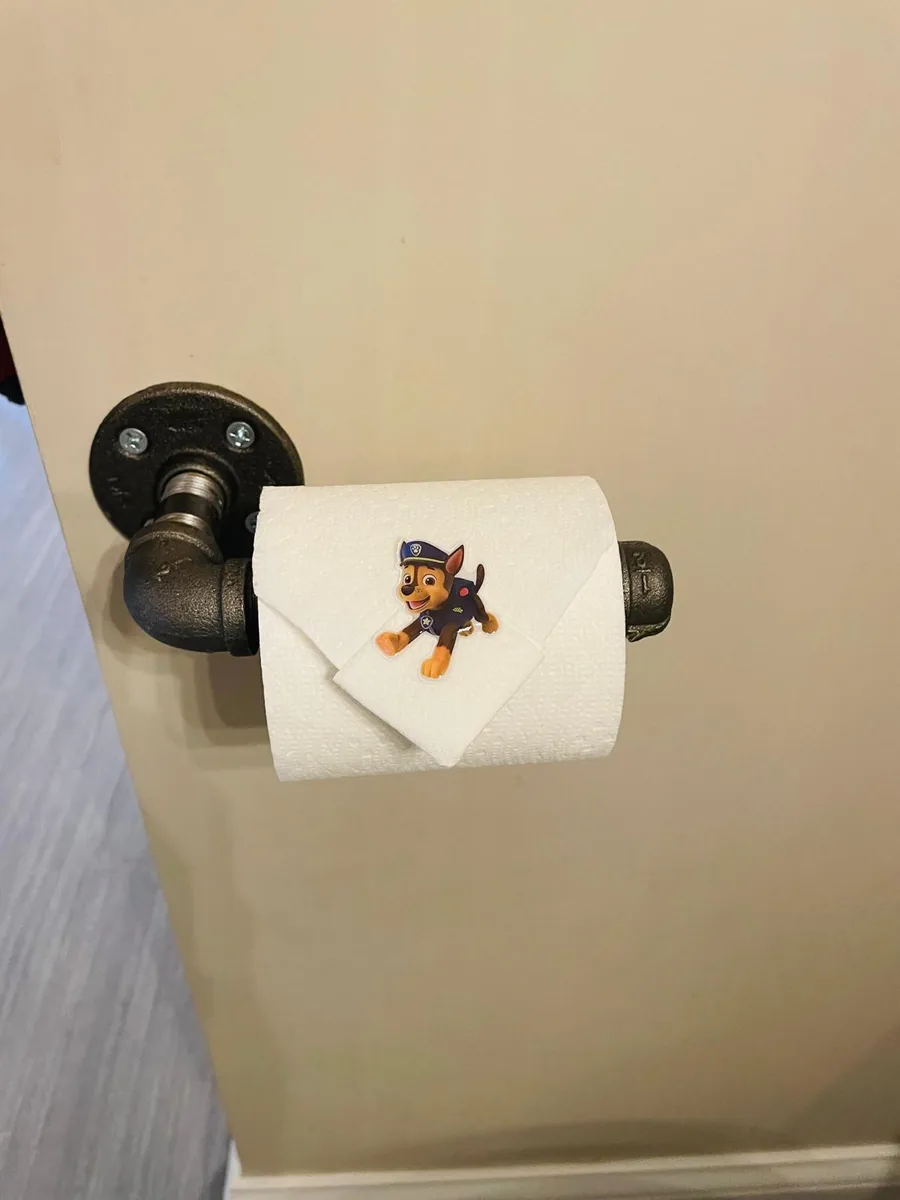 A small cartoon sticker left on folded toilet paper for the children of the house by Dolane Cleaning Services