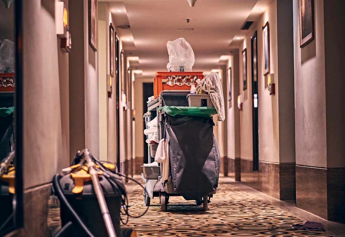 A cleaning cart in a clean, well-kept commercial corridor
